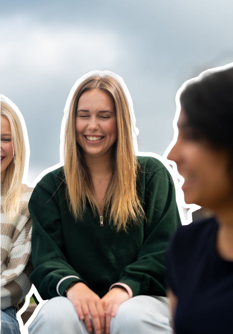 student smiling outside